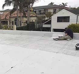 Roofer working on membrane roof